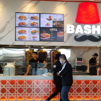 Basha - a woman walking past a restaurant counter - Lebanese Near Me - Richmond, British Columbia Basha - a woman walking past a restaurant counter - Lebanese Near Me - Richmond, British Columbia