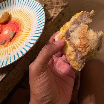 White Castle - a hand holding a half eaten sandwich - Fast Food Near Me - Oak Park, Michigan