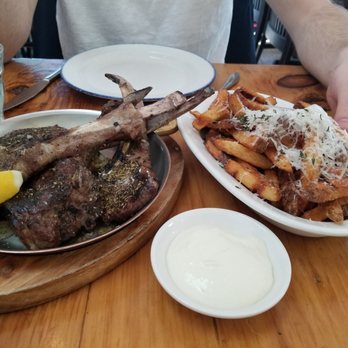 Mamakas Taverna - Lamb chops on top of tzaziki and a side of fries with garlic sauce - Greek Near Me - Toronto, Ontario