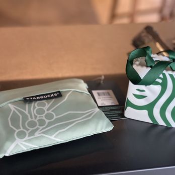 Starbucks - a starbucks bag and a starbucks bag on a table - Coffee & Tea Near Me - Idaho Springs, Colorado