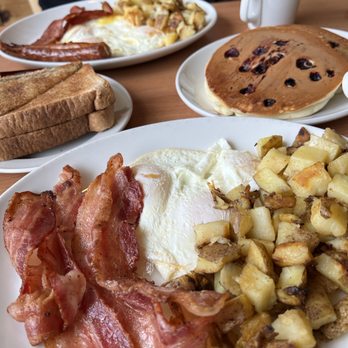 Sunset Grill - a plate of bacon, eggs, toast, and pancakes - Breakfast & Brunch Near Me - Etobicoke, Ontario