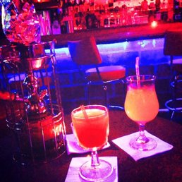 two cocktails on a bar table
