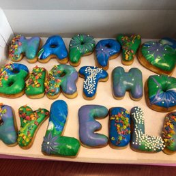 Happy Birthday Donuts in blue, green, and purple. Happy Birthday Donuts in blue, green, and purple.
