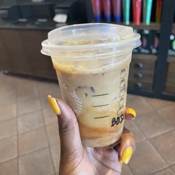 Starbucks - a hand holding a cup of iced coffee - Coffee & Tea Near Me - Fishers, Indiana Starbucks - a hand holding a cup of iced coffee - Coffee & Tea Near Me - Fishers, Indiana