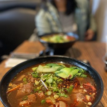 Mifen101 - a woman sitting at a table with a bowl of soup - Soup Near Me - Mountain View, California Mifen101 - a woman sitting at a table with a bowl of soup - Soup Near Me - Mountain View, California