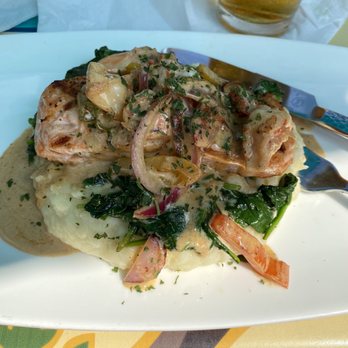 Surf House - Salmon and Shrimp over sautéed spinach and mashed potatoes. Perfectly portioned and cooked. Cream sauce was divine. - New American Near Me - Frederick, Maryland