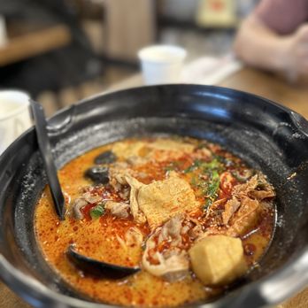 YGF Malatang - a bowl of soup on a table - Noodles Near Me - Milpitas, California YGF Malatang - a bowl of soup on a table - Noodles Near Me - Milpitas, California
