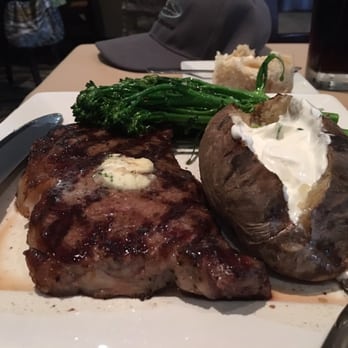 The River Steakhouse - 16 oz rib eye steak, baked potato, broccoli - Steakhouses Near Me - Porterville, California The River Steakhouse - 16 oz rib eye steak, baked potato, broccoli - Steakhouses Near Me - Porterville, California