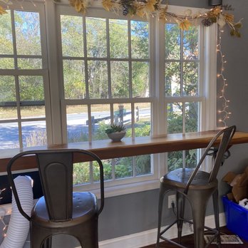Alainas Coffee & Kitchen - a table and chairs in front of a window - Coffee & Tea Near Me - Richmond, Rhode Island Alainas Coffee & Kitchen - a table and chairs in front of a window - Coffee & Tea Near Me - Richmond, Rhode Island