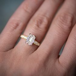 Fashioned from platinum & 18k gold, this one-of-a-kind Erika Winters Minna Solitaire features a 1.82 carat emerald-cut lab grown diamond.