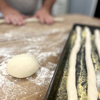 Milan's Market - a person rolling dough on a table - Food Trucks Near Me Milan's Market - a person rolling dough on a table - Food Trucks Near Me