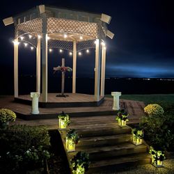 Gazebo lit up at night. We rented a custom made cross and lanterns.