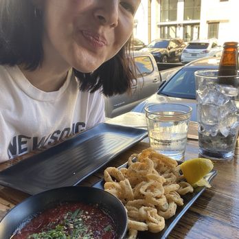 Homeslice - happy girl eating super free and gluten free calamari - Italian Near Me - Dana Point, California