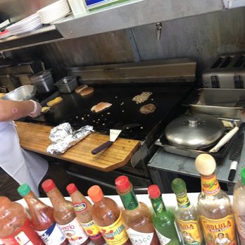 The White Spot Cafe - That's my halibut being cooked as viewed from the counter. - American Near Me - Anchorage, Alaska