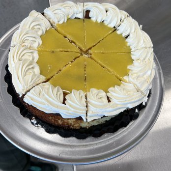 Foodies - a cake with white frosting on a silver platter - Cafes Near Me - Auburn, Alabama Foodies - a cake with white frosting on a silver platter - Cafes Near Me - Auburn, Alabama
