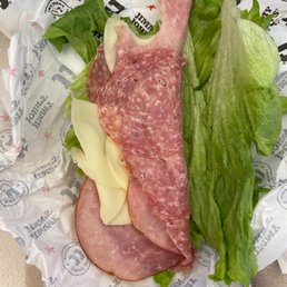 a sandwich with meat and lettuce