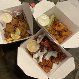 three boxes of food on a table