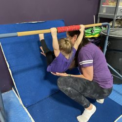 Libertyville Gymnastics Academy - Holding onto the bar and walking toes up the mat