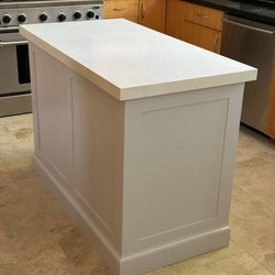 Premier Granite - Our kitchen island. Previously it was an old butcher block on top; Premier Granite cut and installed the quartz from just the measurements.