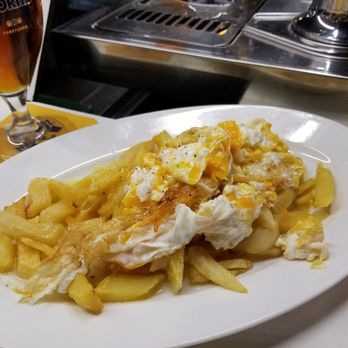 Tapas 24 - Huevos estrellados (fried smashed eggs on a bed of fried potatoes) - Tapas Bars Near Me - Barcelona, B