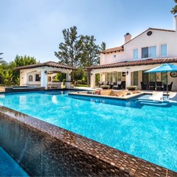 Pacific Pools & Patios - Vanishing edge w/ glass tile and travertine