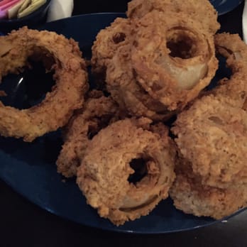MOJO Hogtown Bar-B-Que - Monster-size onion rings - a little heavily breaded, but seasoned well and plenty to share! - Barbeque Near Me - Gainesville, Florida MOJO Hogtown Bar-B-Que - Monster-size onion rings - a little heavily breaded, but seasoned well and plenty to share! - Barbeque Near Me - Gainesville, Florida