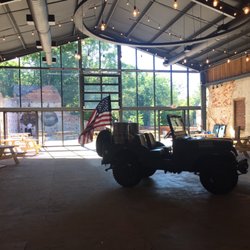Oconee Brewing - Two round disks on the left are from the original building (old mill). Plenty of picnic tables and games on right side