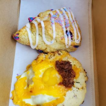 The Crafted Scone - Unicorn scone on top which is a vanilla flavor with light icing. Bacon, cheeses and eggs scone on the bottom. Both thumbs up! - Bakeries Near Me - Murrieta, California The Crafted Scone - Unicorn scone on top which is a vanilla flavor with light icing. Bacon, cheeses and eggs scone on the bottom. Both thumbs up! - Bakeries Near Me - Murrieta, California