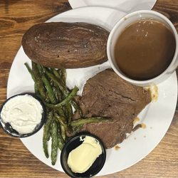 The Carriage House Bistro and Tavern - Pot roast with side of gravy baked potato and asparagus