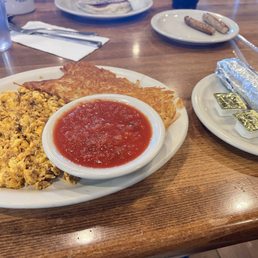 Scrambled eggs with chorizo, hash browns and tortillas.