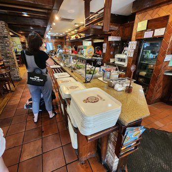 la Madeleine - a woman standing at a counter in a restaurant - Breakfast & Brunch Near Me - Columbia, Maryland