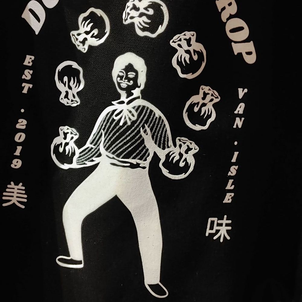 Dumpling Drop - a black tote bag with a white design - Dumplings Near Me - Victoria, British Columbia