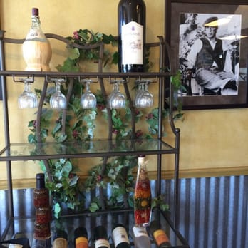Cibelli’s Pizza - a rack of wine glasses and bottles - Pizza Near Me - Redmond, Oregon