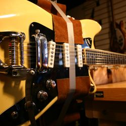 Stahman Guitars - Modern, precise techniques are essential in my shop. Here I've got a Vox Tempest XII in a neck jig for fret work and setup.