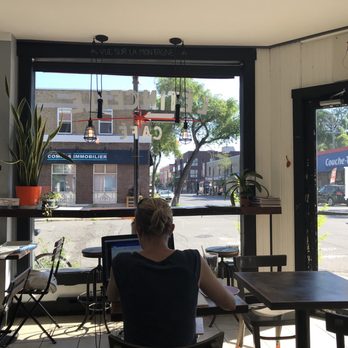 Café l'Étincelle - a woman sitting at a table - Coffee & Tea Near Me - Montreal, Quebec