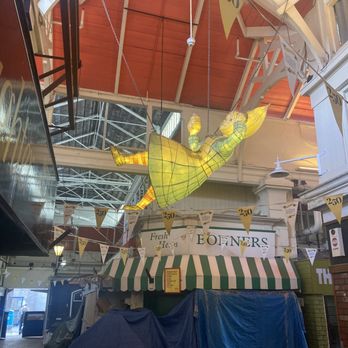 Oxford Covered Market - Alice falls down the rabbit hole... Alice-themed art is suspended above throughout the Market - Farmers Market Near Me - Oxford, OXF Oxford Covered Market - Alice falls down the rabbit hole... Alice-themed art is suspended above throughout the Market - Farmers Market Near Me - Oxford, OXF