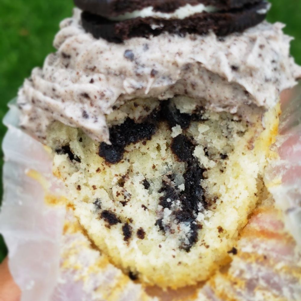 Parks Pastries - a hand holding a half eaten cupcake - Cupcakes Near Me - Homewood, Illinois Parks Pastries - a hand holding a half eaten cupcake - Cupcakes Near Me - Homewood, Illinois
