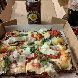 A really good veggie combo pizza with tomato and cheese and basil