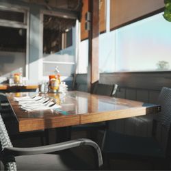 Proud Mary's Restaurant - Dining tables with the sun shining through.