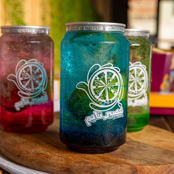 Aseer Time - three jars of liquid sitting on a cutting board - Juice Bars & Smoothies Near Me - Mississauga, Ontario