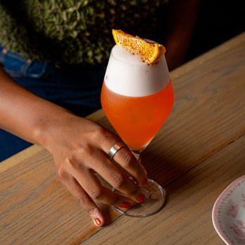 Fritz Cocktail Bar - a woman's hand holding a cocktail - Cocktail Bars Near Me - Brooklyn, New York Fritz Cocktail Bar - a woman's hand holding a cocktail - Cocktail Bars Near Me - Brooklyn, New York