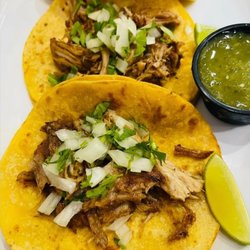 Cafe Latino - Authentic street-style tacos served on golden corn tortillas, piled high with tender, slow-cooked meat, fresh cilantro, diced onions.