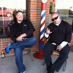 Sloss Barber Shop - Nathan Sloss and Steve Boone, two of our employees sitting outside the shop near our barber pole.