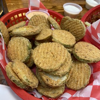 JT's Cafe - Fried Pickles - A basket of fried pickles served with dipping sauces, placed on a wooden table at JT's Cafe in Blue Point, NY. - Breakfast & Brunch Near Me - Blue Point, New York