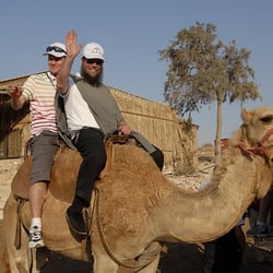 Shalom Israel Tours - Happy clients riding a camel near the Dead Sea!