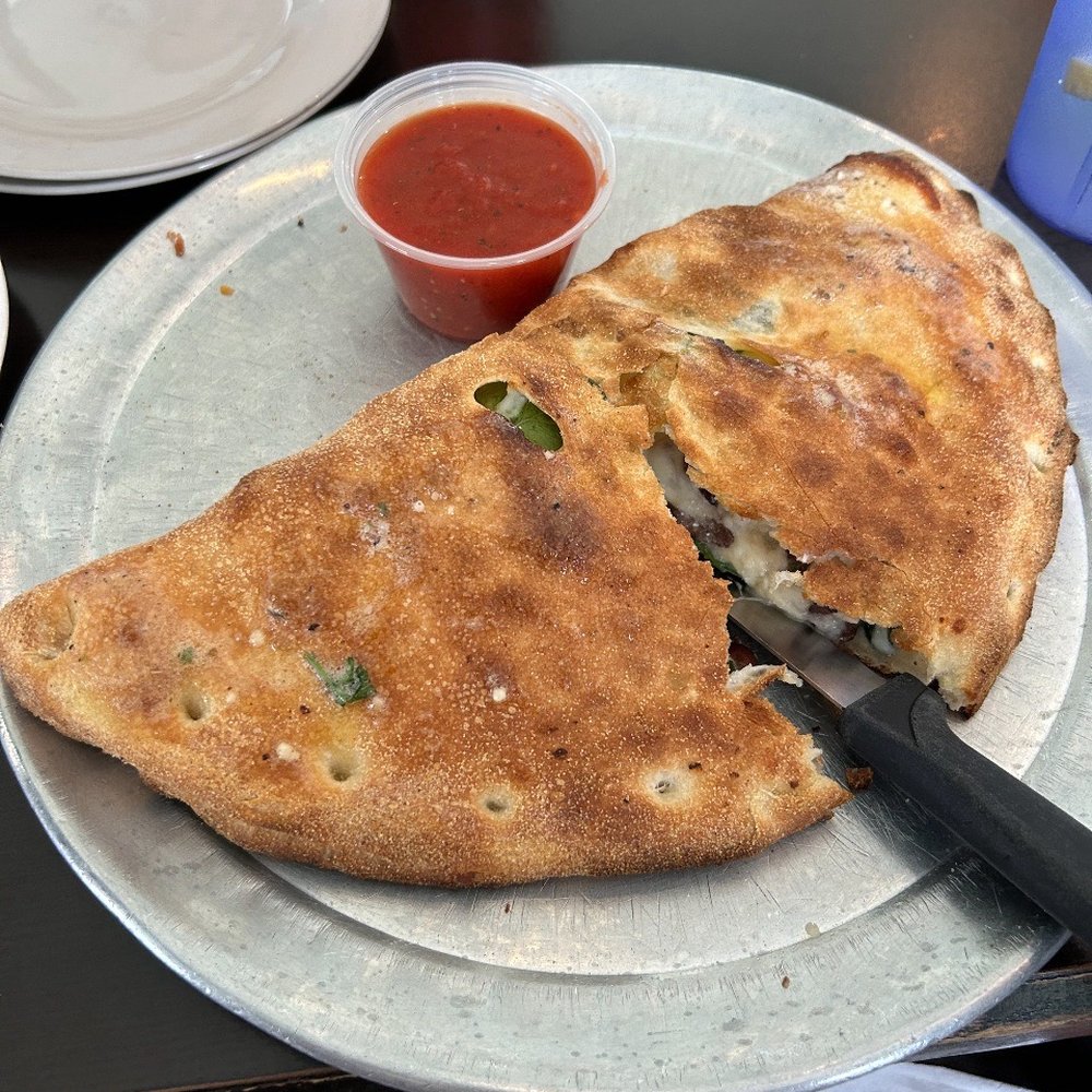 Ale Pie House - Mediterranean Calzone - Fresh spinach, feta cheese, fresh kalamata olive and blended mozzarella. - Italian Near Me - Orange Park, Florida Ale Pie House - Mediterranean Calzone - Fresh spinach, feta cheese, fresh kalamata olive and blended mozzarella. - Italian Near Me - Orange Park, Florida