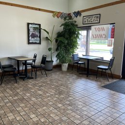 a dining area with tables and chairs