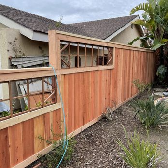 Sergios Construction - a wooden fence with a window - General Contractors Near Me Sergios Construction - a wooden fence with a window - General Contractors Near Me