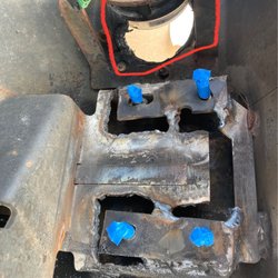 Johnny's Car Care - Red circle shows the light housing that has been melted by the terrible weld job they did.