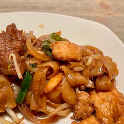 Golden Dragon Chinese Food - House Special Chow Fun. Flat rice noodles with chicken, beef, and shrimp. Bean sprouts and onions top this dish.